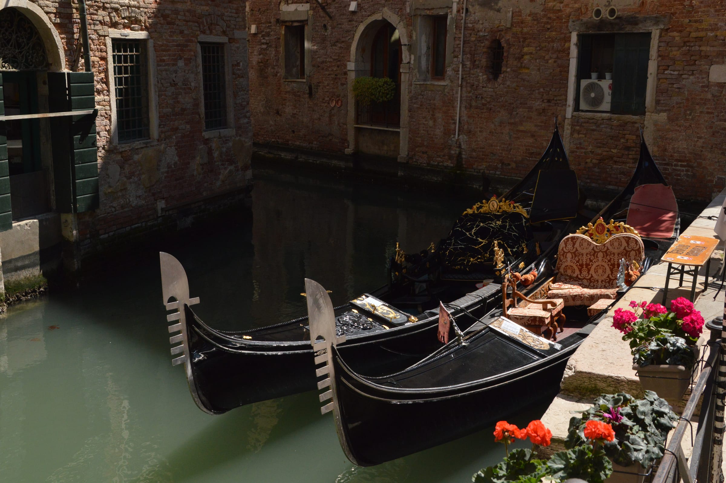 Gondolas moored along a quiet canal in Venice